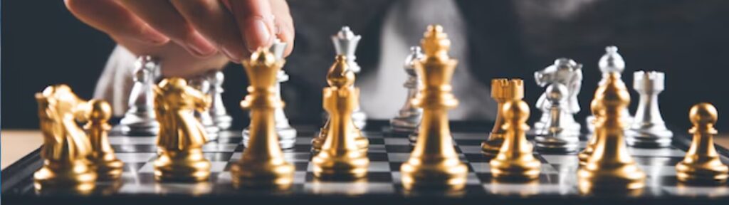 A hand strategically moving a chess piece on a chessboard, symbolizing the planning involved in choosing between Medicare Advantage Plans.