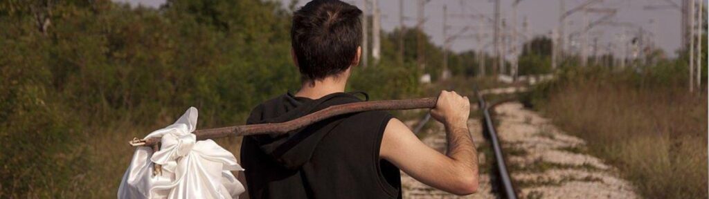 Man carrying essentials on a stick symbolizing minimal health insurance coverage