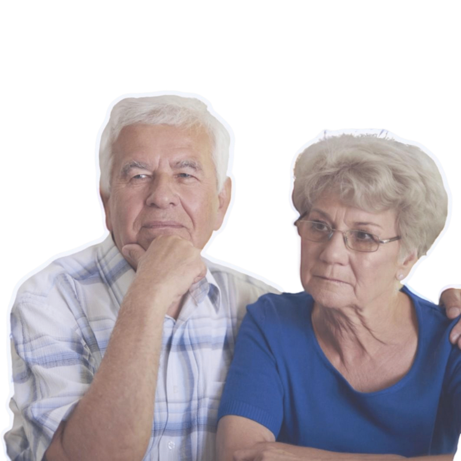 Elderly couple sitting at a table, consulting with The Medicare Broker for Medicare advice.